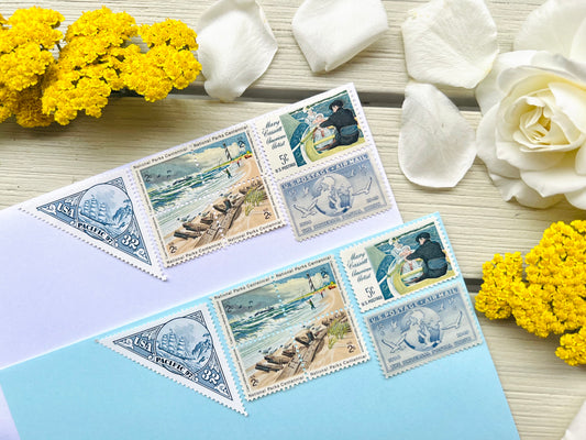 Vintage Postage Stamps on light blue and white envelopes in beach theme