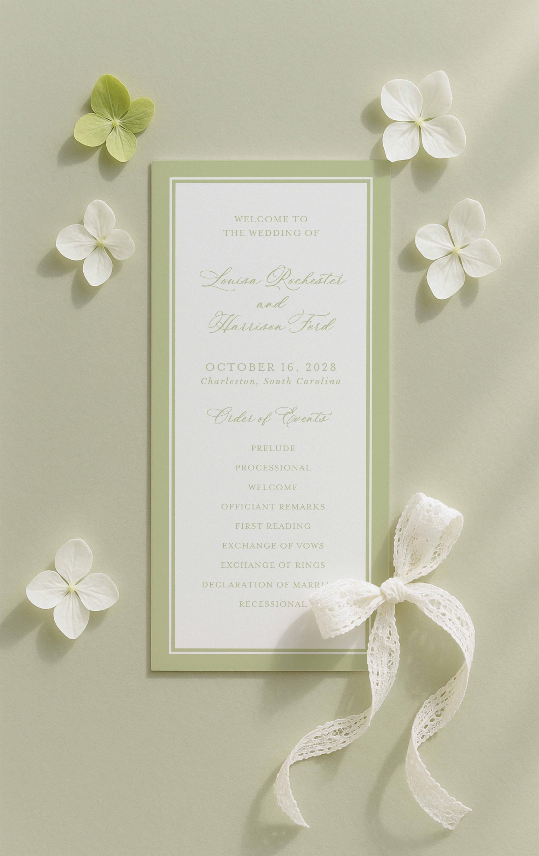 a wedding invitation card with a green and white color scheme, surrounded by white flowers and a white ribbon.