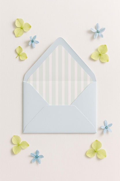 a light blue envelope with a white striped pattern, surrounded by small blue and yellow flowers on a light pink background.