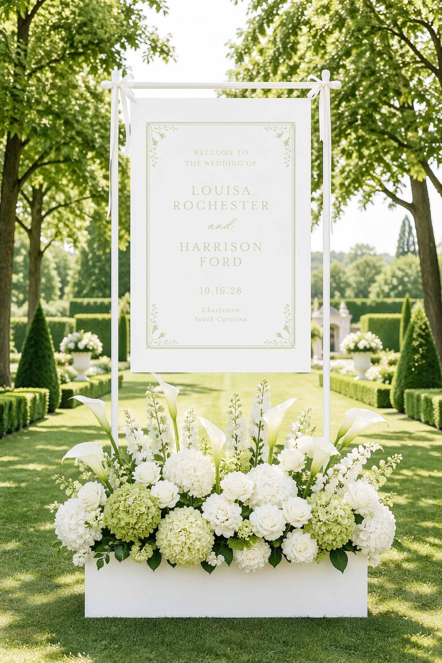 A white sign with a floral arrangement in front of it, welcoming guests to the wedding of Louisa Rochester and Harrison Ford.