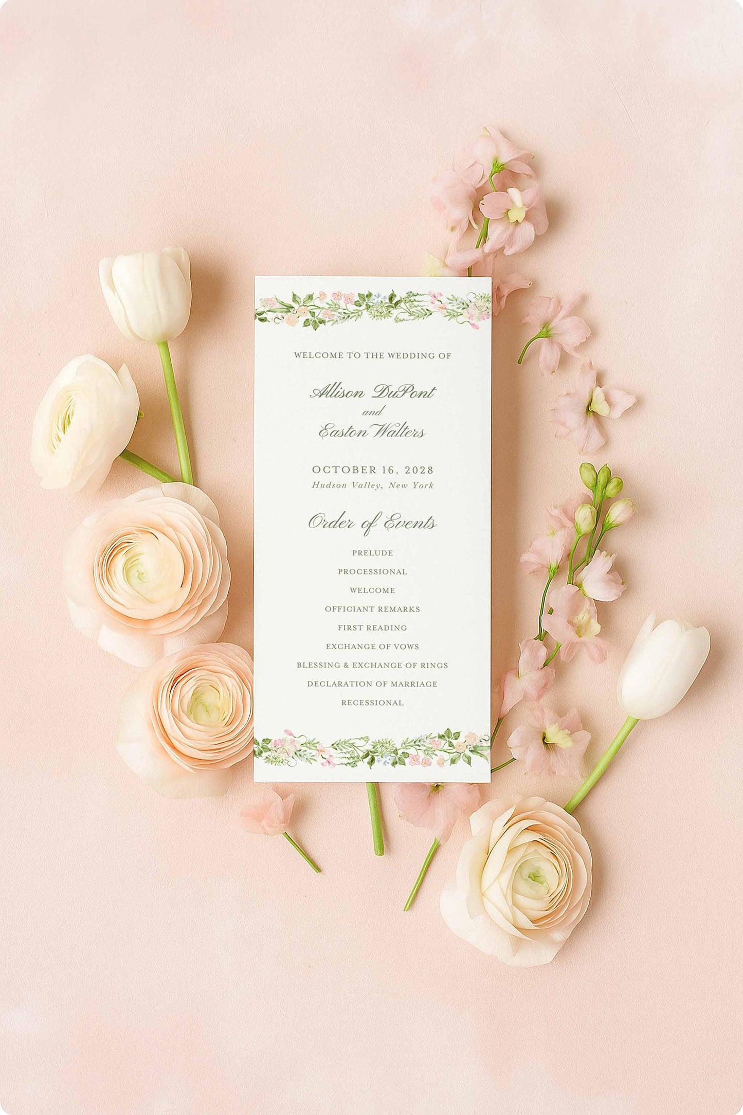 a wedding invitation card surrounded by pink roses and white tulips on a pink background.