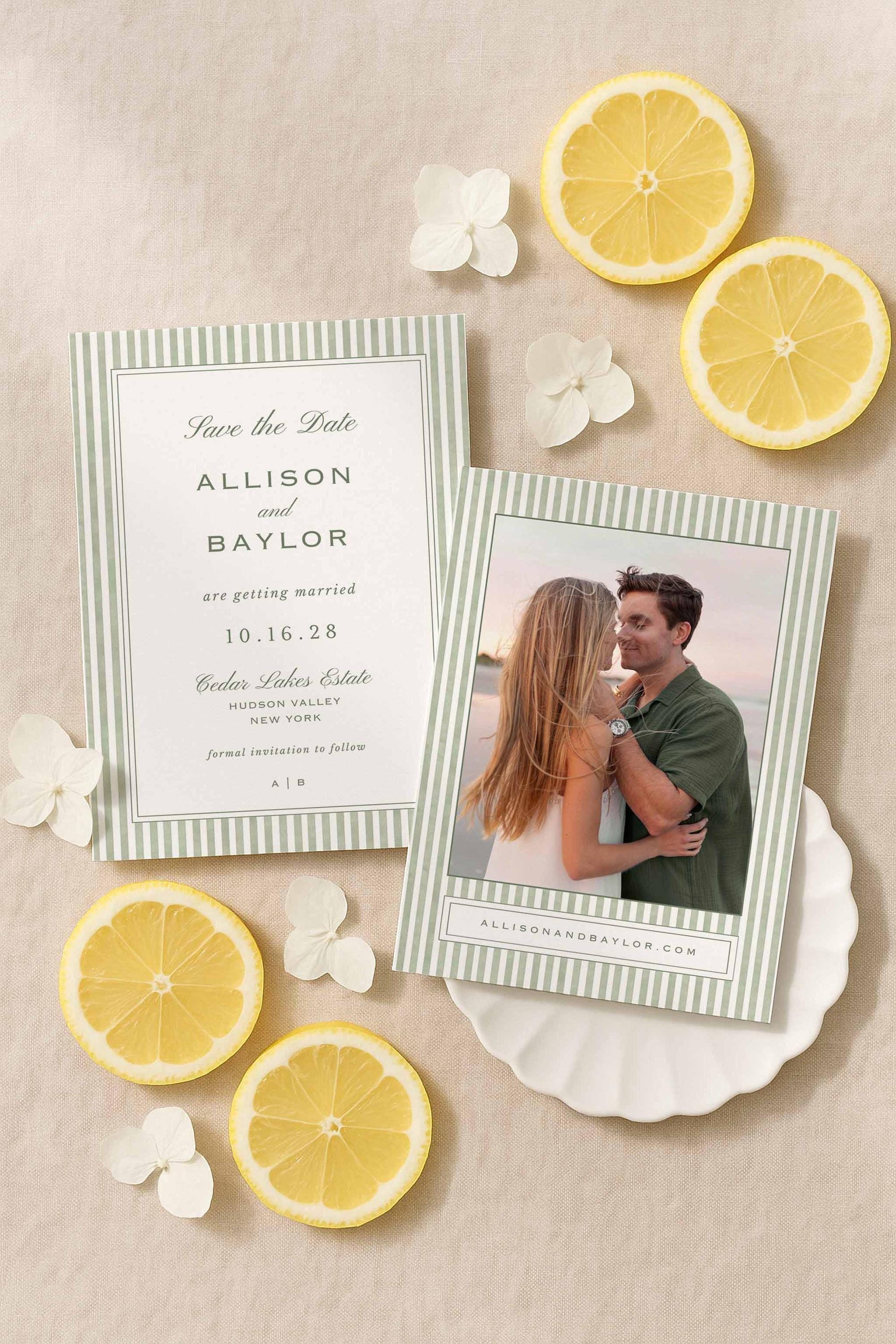 Green striped watercolor Save the Date card with engagement photos, styled with lemons and white flowers.
