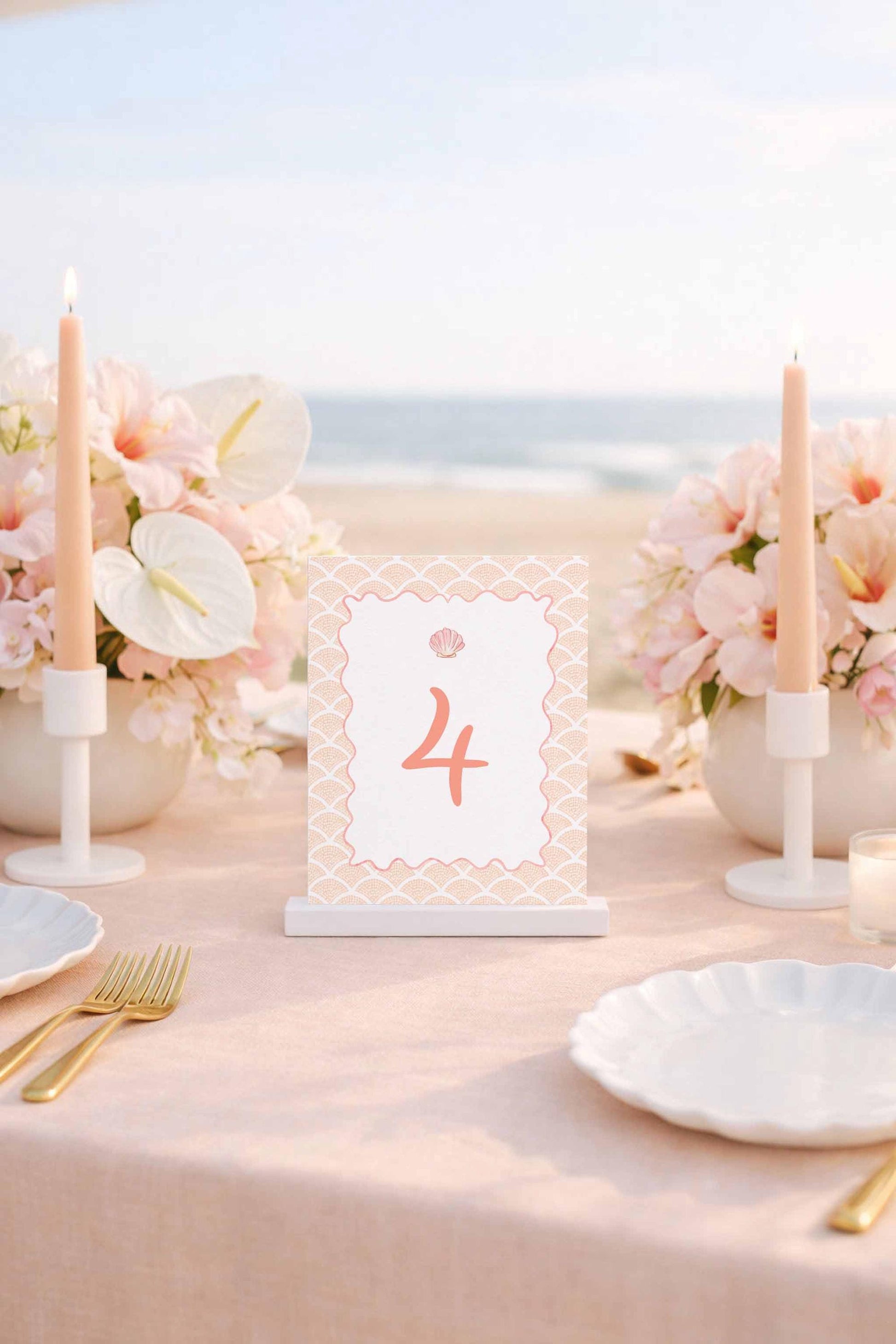 a table set for a romantic dinner, with a tablecloth, candles, flowers, and place settings.