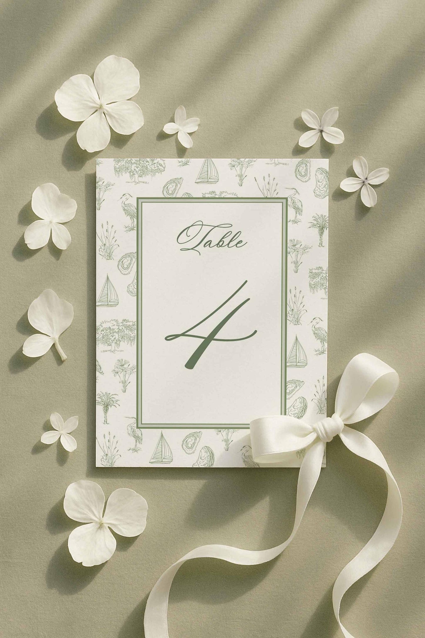 Coastal southern toile table number featuring palmetto, egret, oyster, and marsh elements