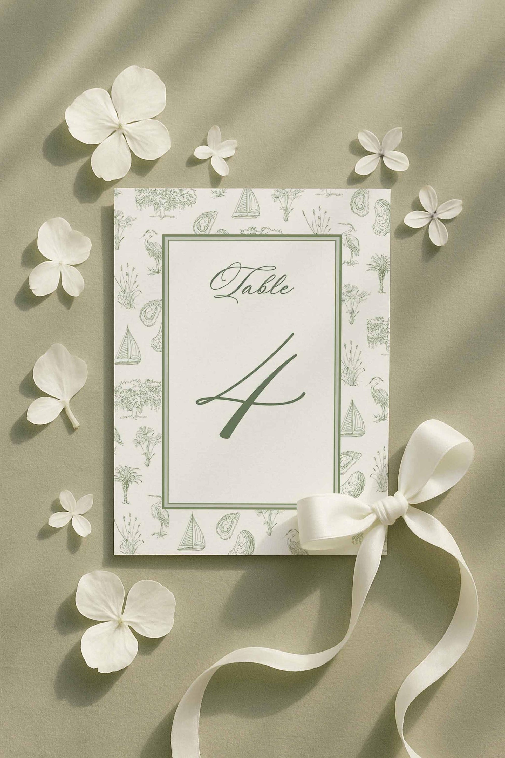 Coastal southern toile table number featuring palmetto, egret, oyster, and marsh elements