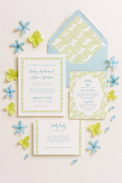 a wedding invitation, an envelope, and some blue and yellow flowers arranged on a white background.