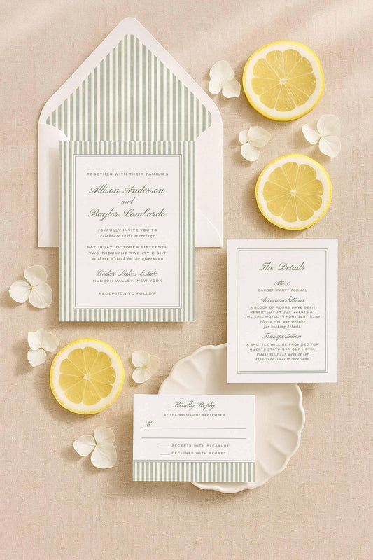 Green watercolor stripe wedding invitation suite including the main invite, detail card, envelope liner, and RSVP displayed with citrus and soft floral accents.
