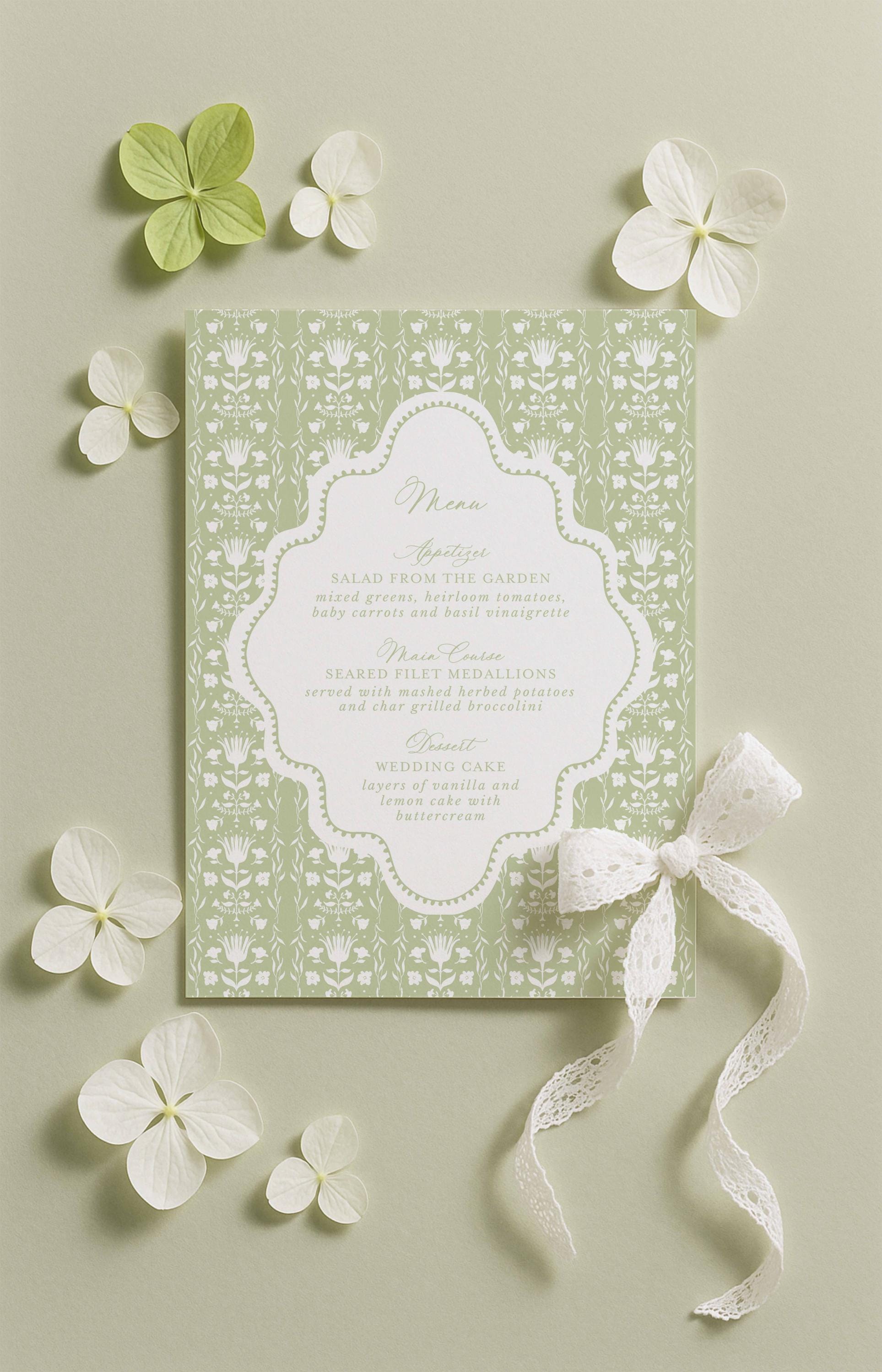 a green and white menu card with a decorative bow, surrounded by white flowers and a lace ribbon.