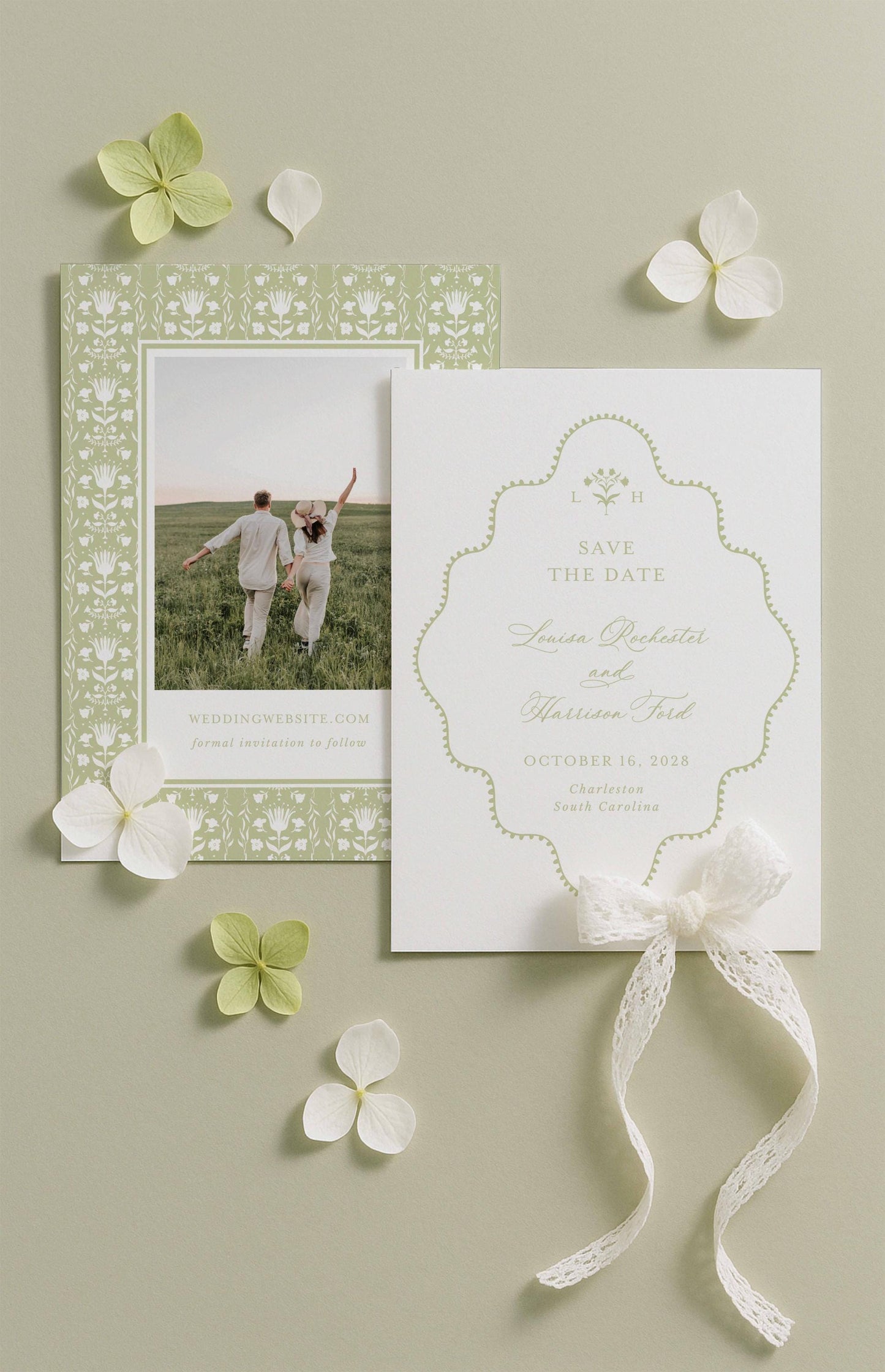 a wedding invitation card with a couple standing in a field, surrounded by white flowers and a white ribbon.