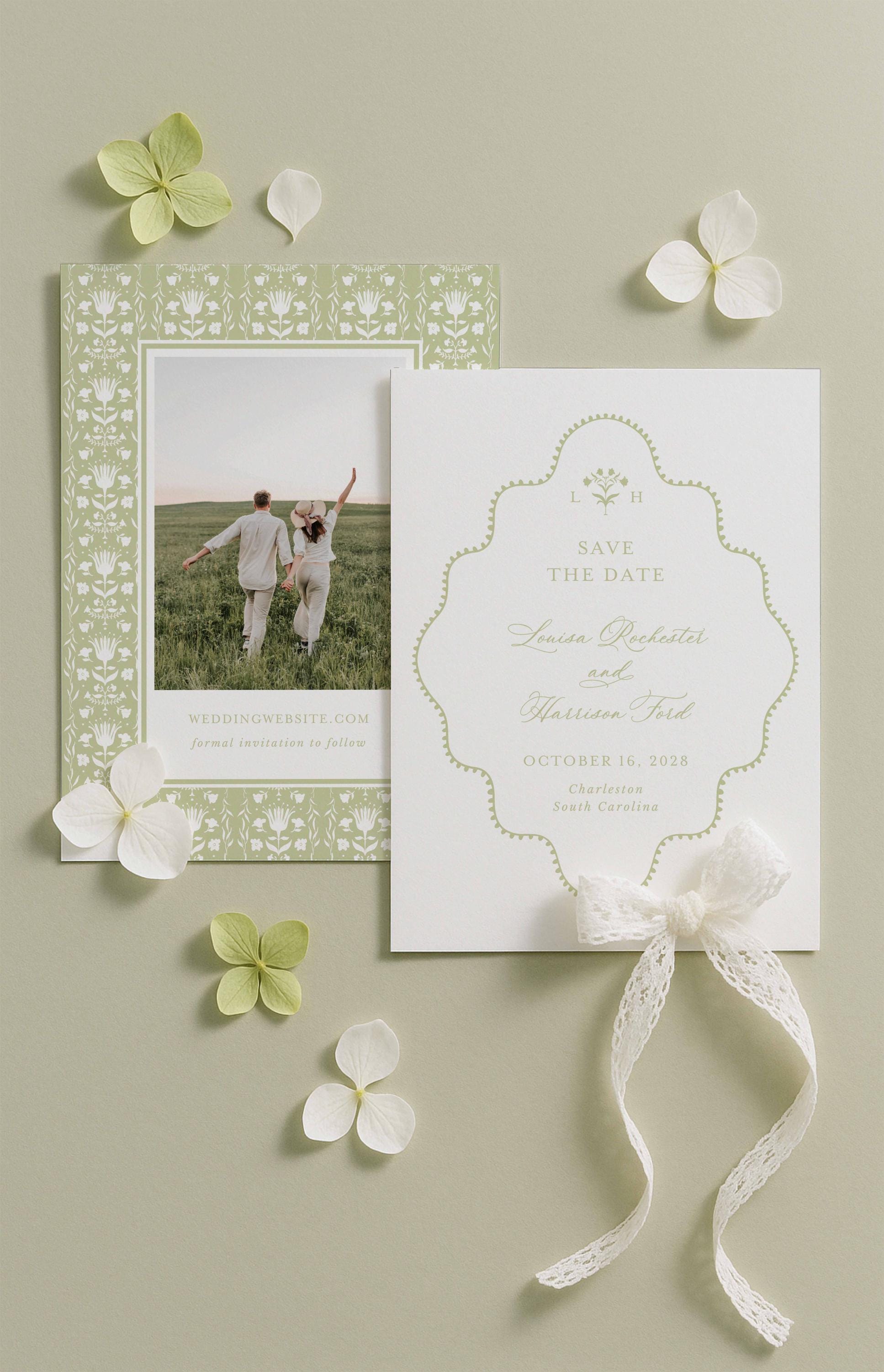 a wedding invitation card with a couple standing in a field, surrounded by white flowers and a white ribbon.