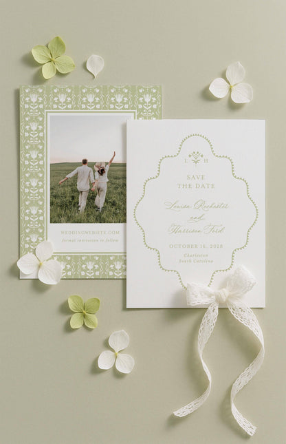 a wedding invitation card with a couple standing in a field, surrounded by white flowers and a white ribbon.