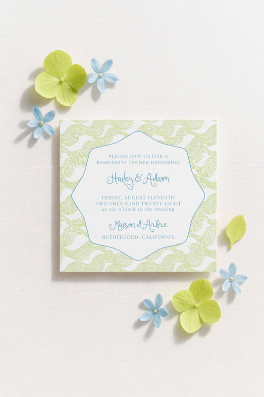The image is a wedding invitation card with a light green and white color scheme, featuring a floral design and text inviting guests to a rehearsal dinner.