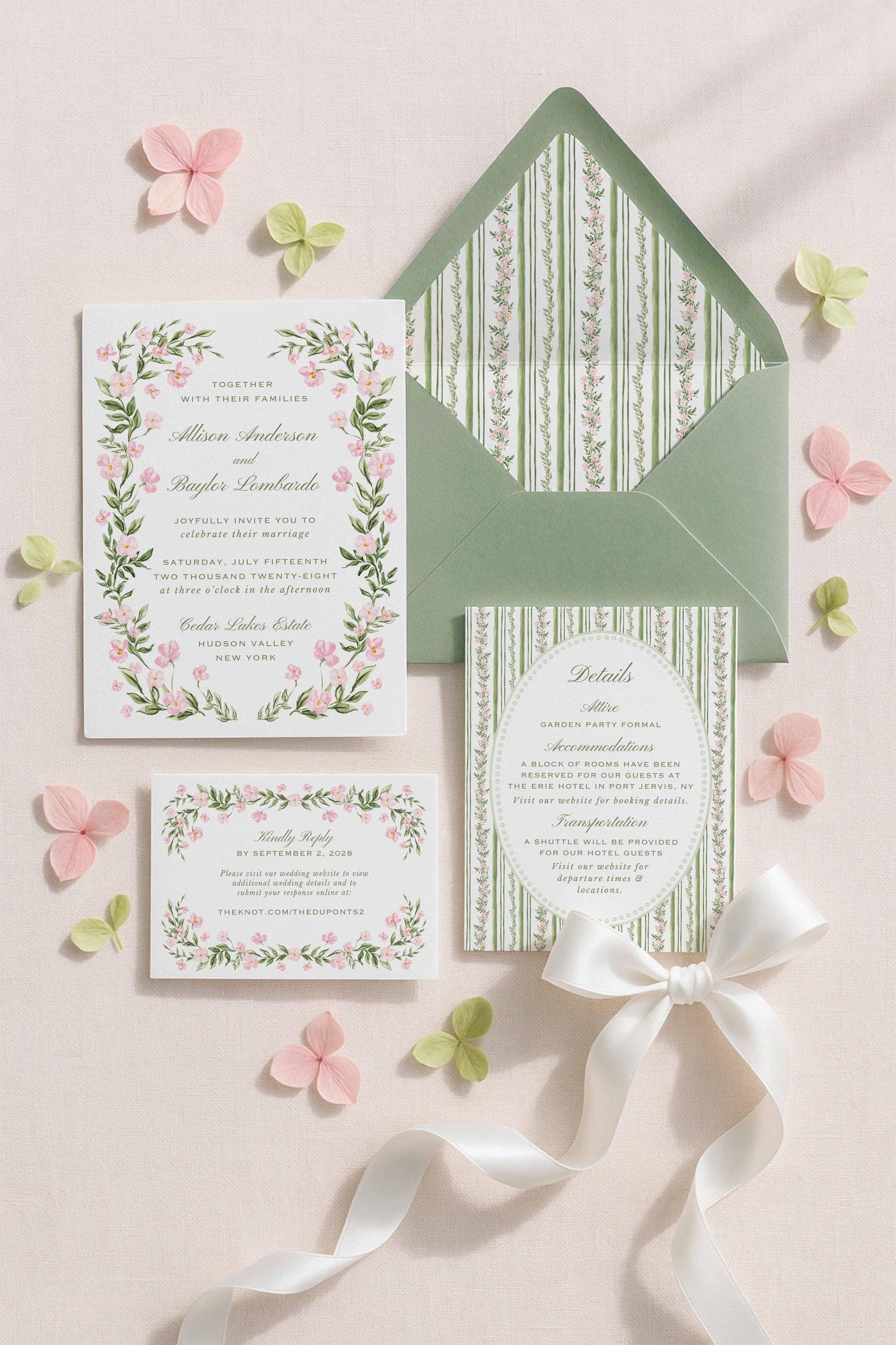 a wedding invitation set against a light pink background, surrounded by pink and green floral elements, and a green envelope.