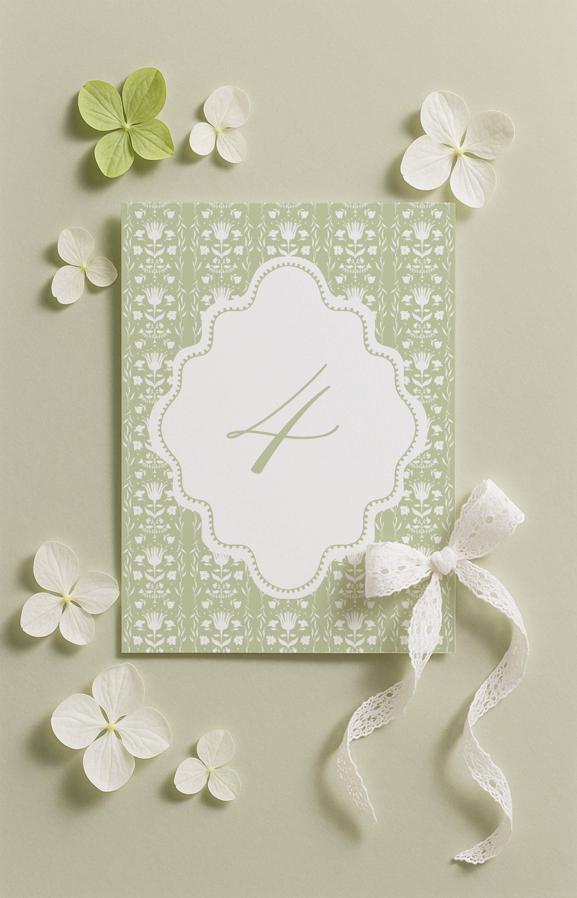 a green and white floral design with a white ribbon and a small white flower, all set against a light green background.