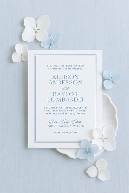 The image is a wedding invitation card for the marriage of Allison Anderson and Bayl Lombardo. The card is set against a light blue background and features white text and blue floral accents.