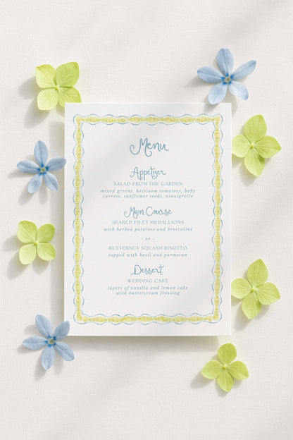a white menu card with blue and green accents, surrounded by blue and green flowers.
