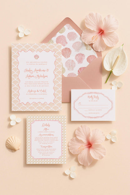 a wedding invitation with a pink and white color scheme, surrounded by pink flowers and seashells.