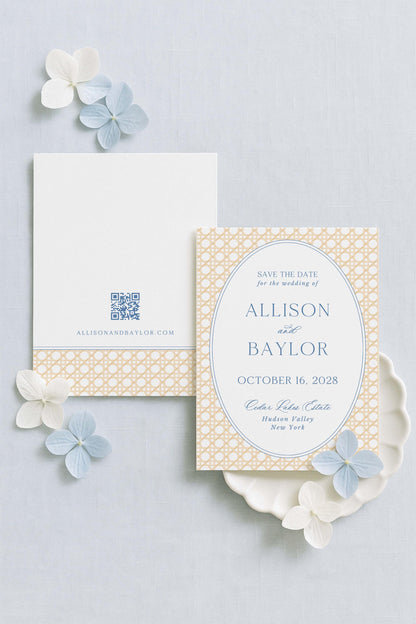 a wedding invitation card with a floral design and a QR code, placed on a light blue background with white flowers.
