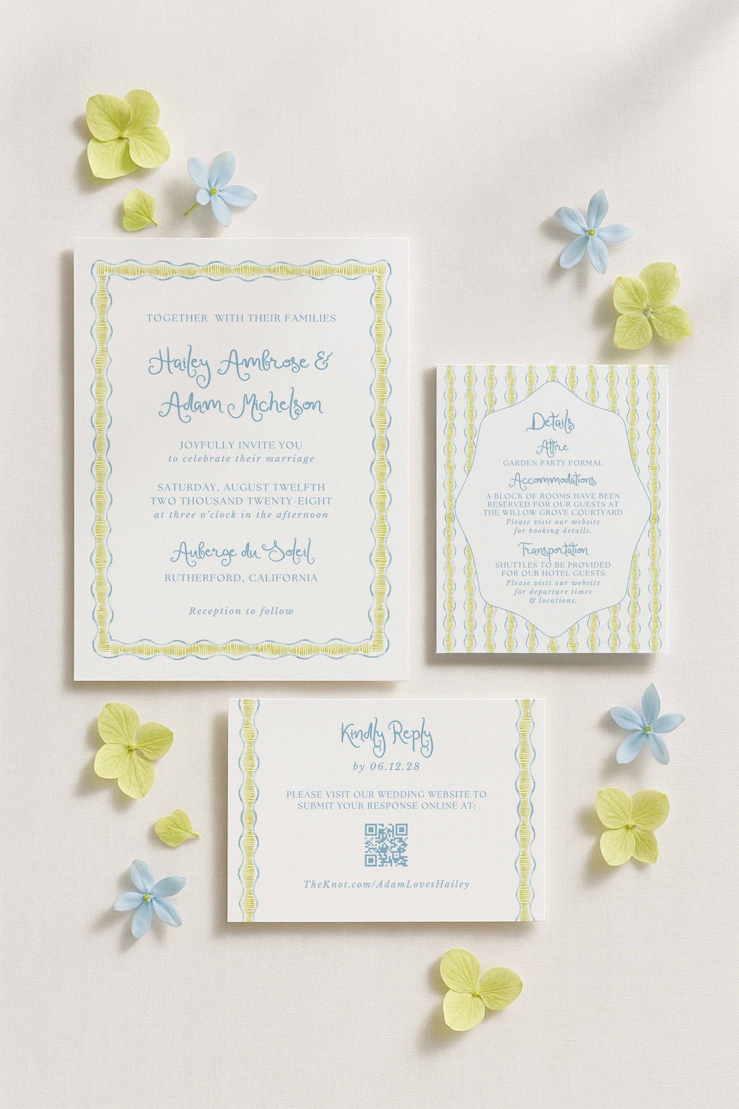 a wedding invitation, a response card, and some blue and yellow flowers arranged on a white background.
