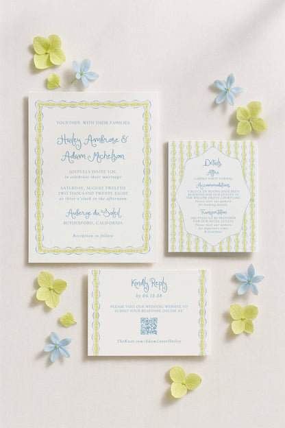 a wedding invitation, a response card, and some blue and yellow flowers arranged on a white background.