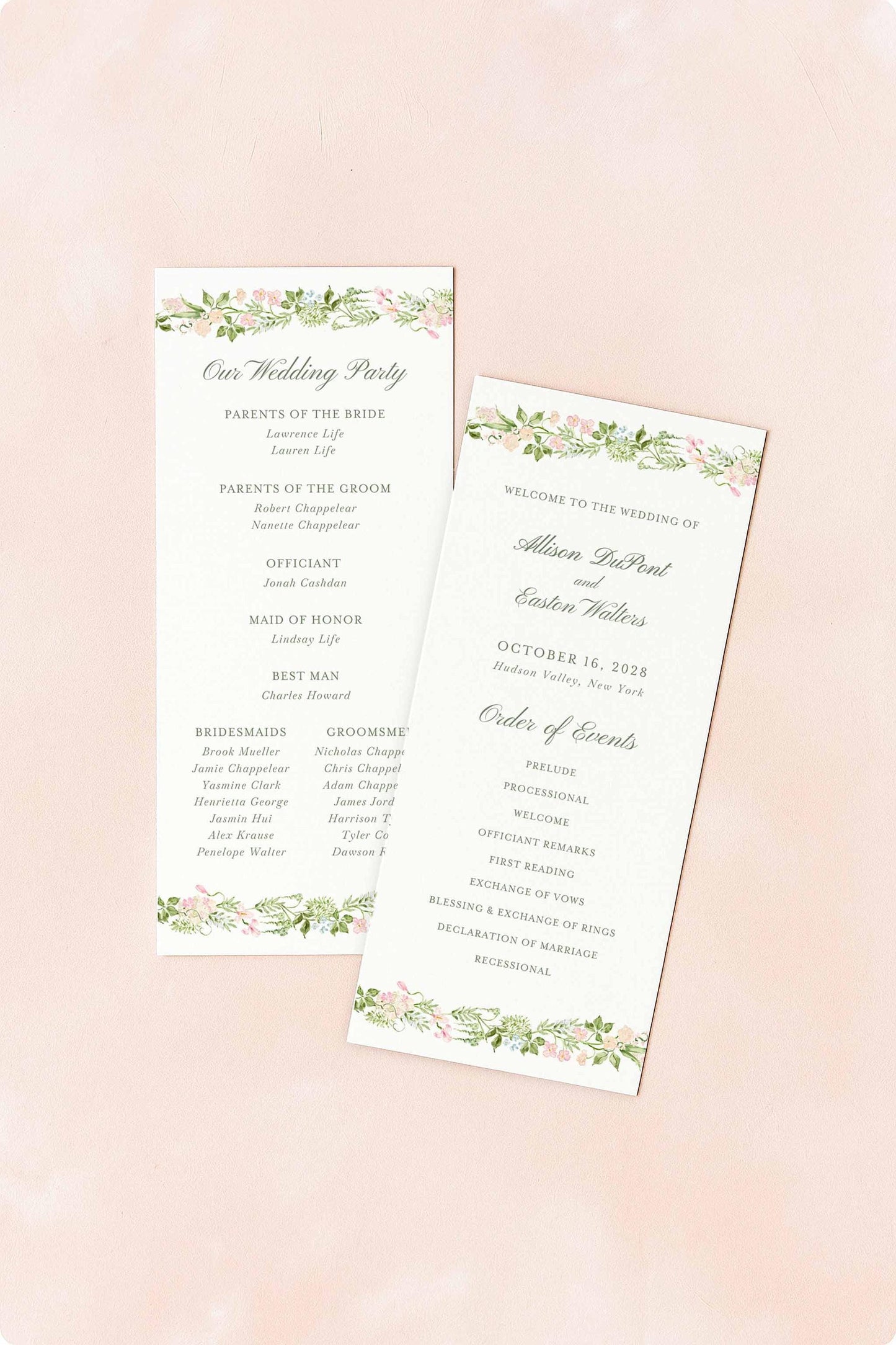 two white wedding programs with floral designs, placed on a pink background.