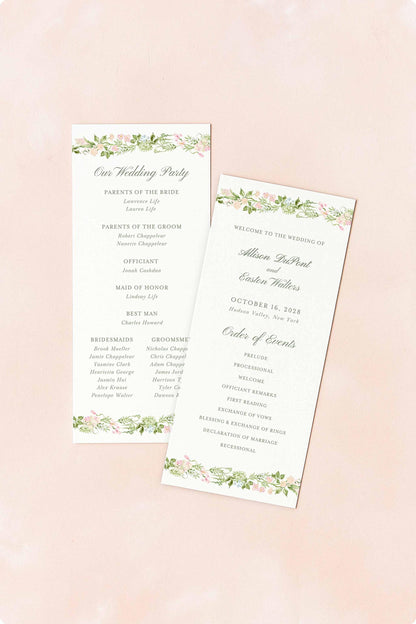 two white wedding programs with floral designs, placed on a pink background.