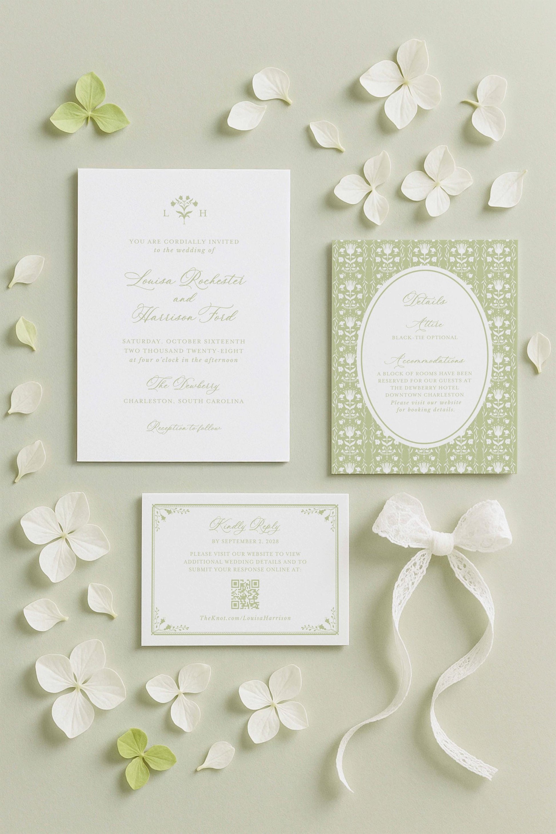a wedding invitation, a small card, and some white flowers arranged on a light background.