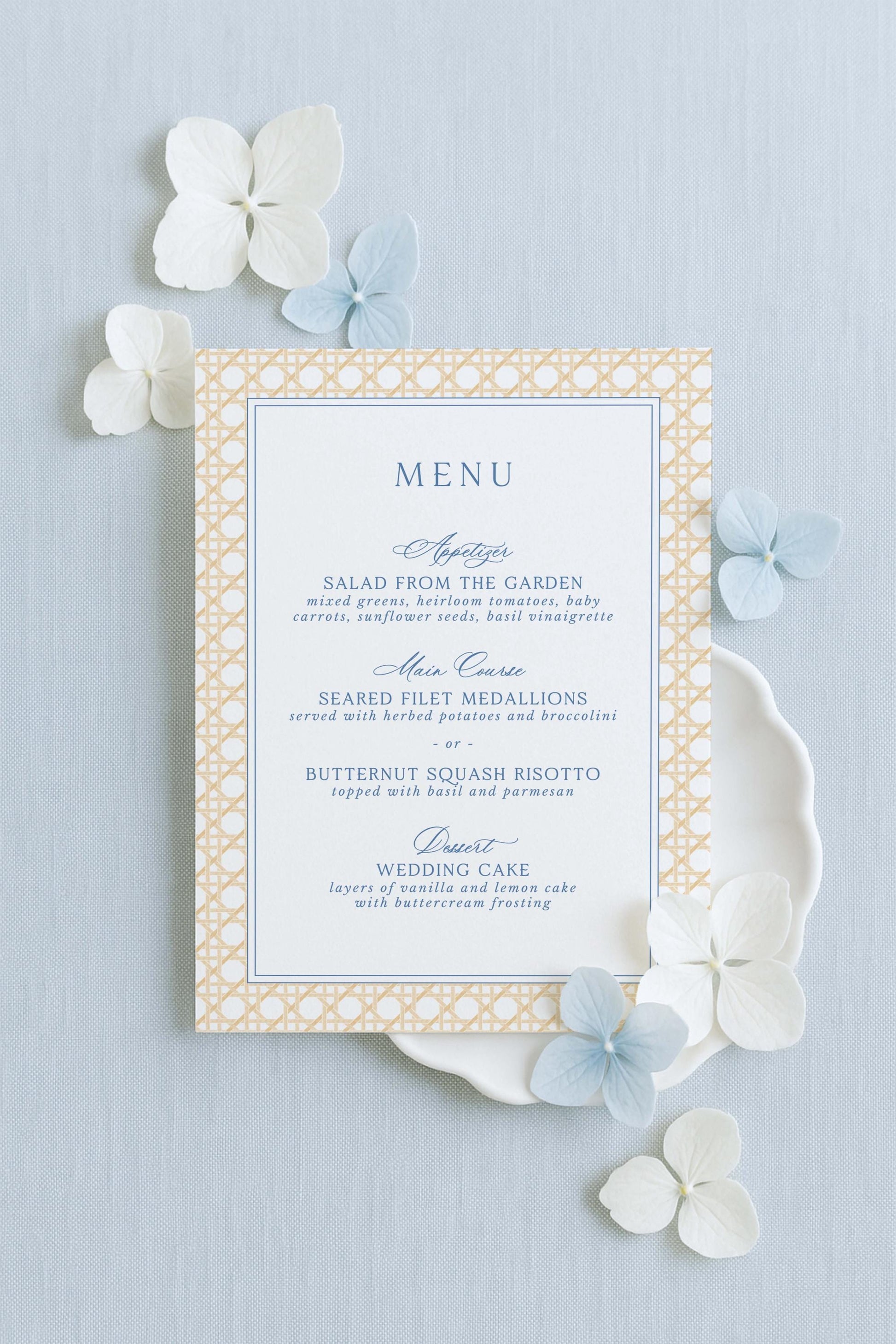 a menu card with a light blue and gold color scheme, placed on a light blue background. The menu card is surrounded by white and light blue flowers, creating a visually appealing and elegant presentation.