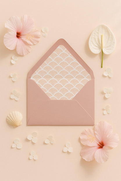 a pink envelope with a patterned paper inside, surrounded by various pink flowers and small white flowers on a light peach background.