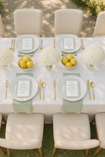 Green striped watercolor wedding menu displayed on a neutral tablescape with lemons and hydrangea florals.