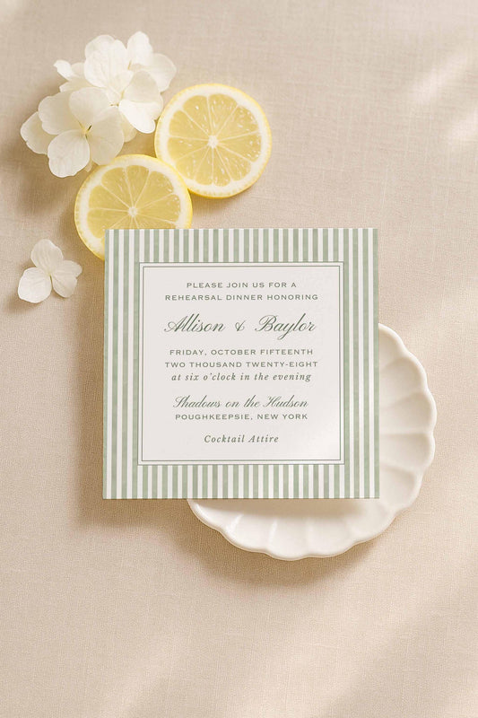 Green watercolor stripe rehearsal dinner invitation surrounded by lemons and soft neutral florals.