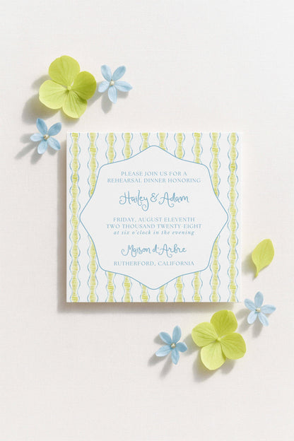 The image is a wedding invitation featuring a blue and white striped pattern, with a floral design and some yellow flowers surrounding it.