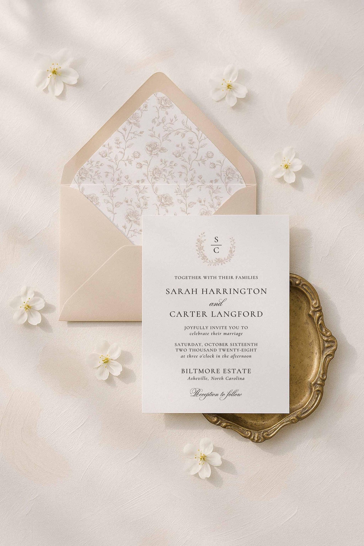 Elegant line art invitation suite styled with soft neutral linens and white florals.