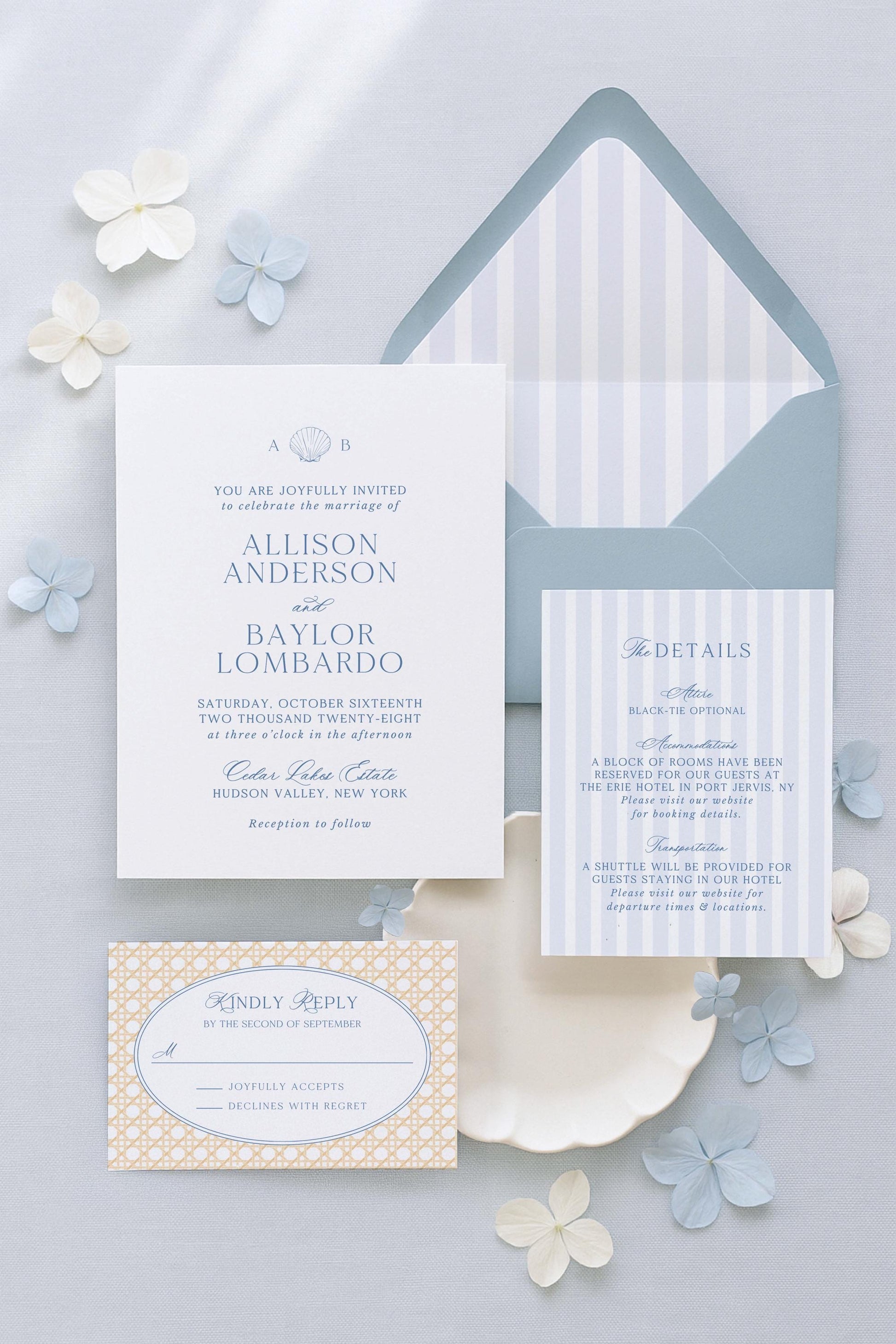 a wedding invitation with a white background, blue and white striped envelope, and a small card with a gold and white pattern. The invitation includes details about the wedding ceremony and reception, and there are some flowers scattered around the invitation.