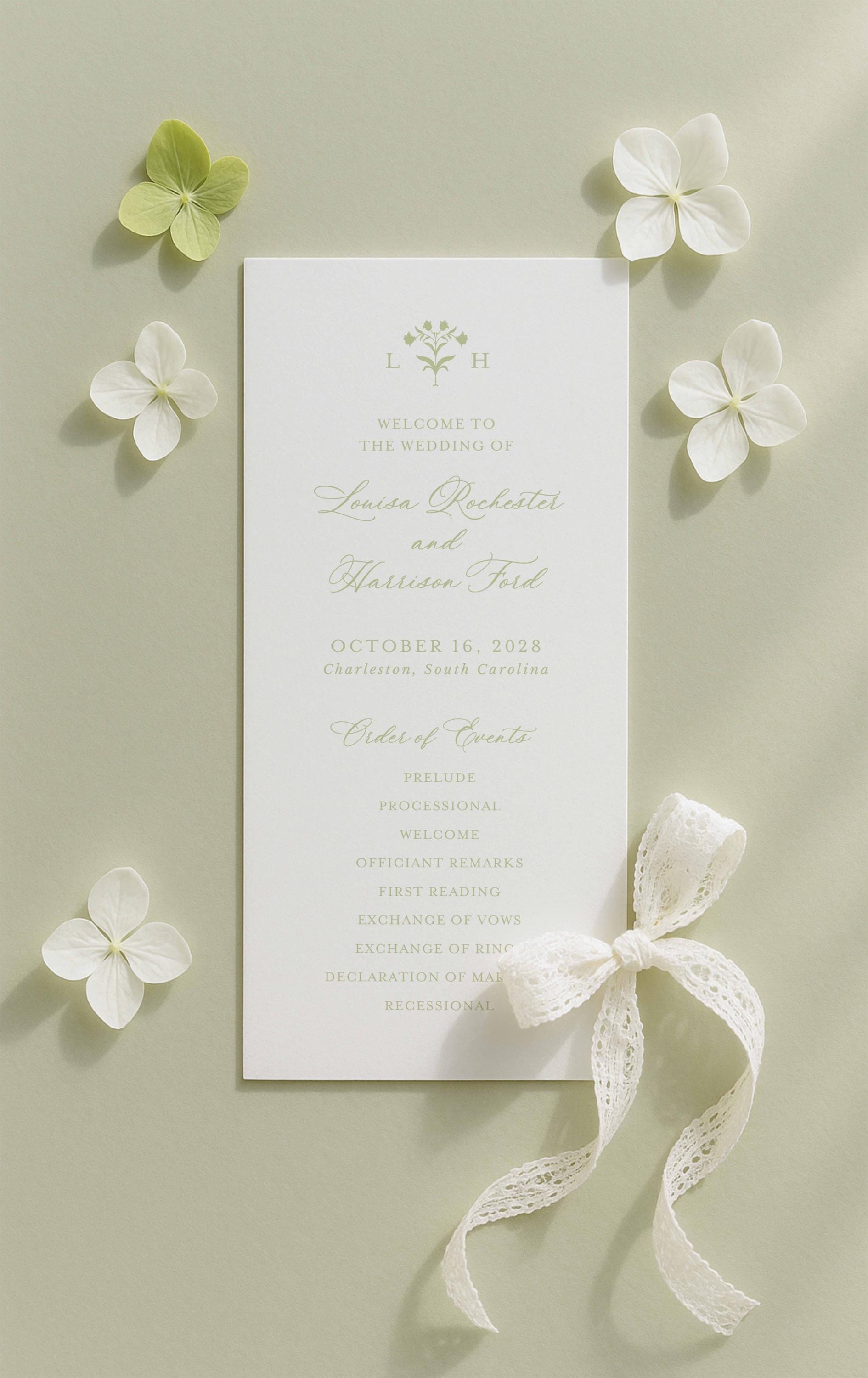 a wedding invitation card with a white background, surrounded by white flowers and a white ribbon.
