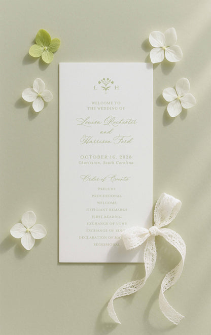 a wedding invitation card with a white background, surrounded by white flowers and a white ribbon.