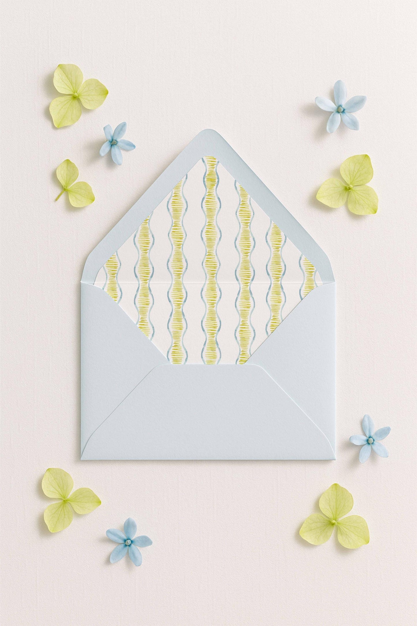 a light blue envelope with a pattern of yellow and blue lines, surrounded by small blue and yellow flowers on a light pink background.