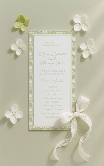 a wedding invitation card with a green and white color scheme, surrounded by white flowers and a white ribbon.