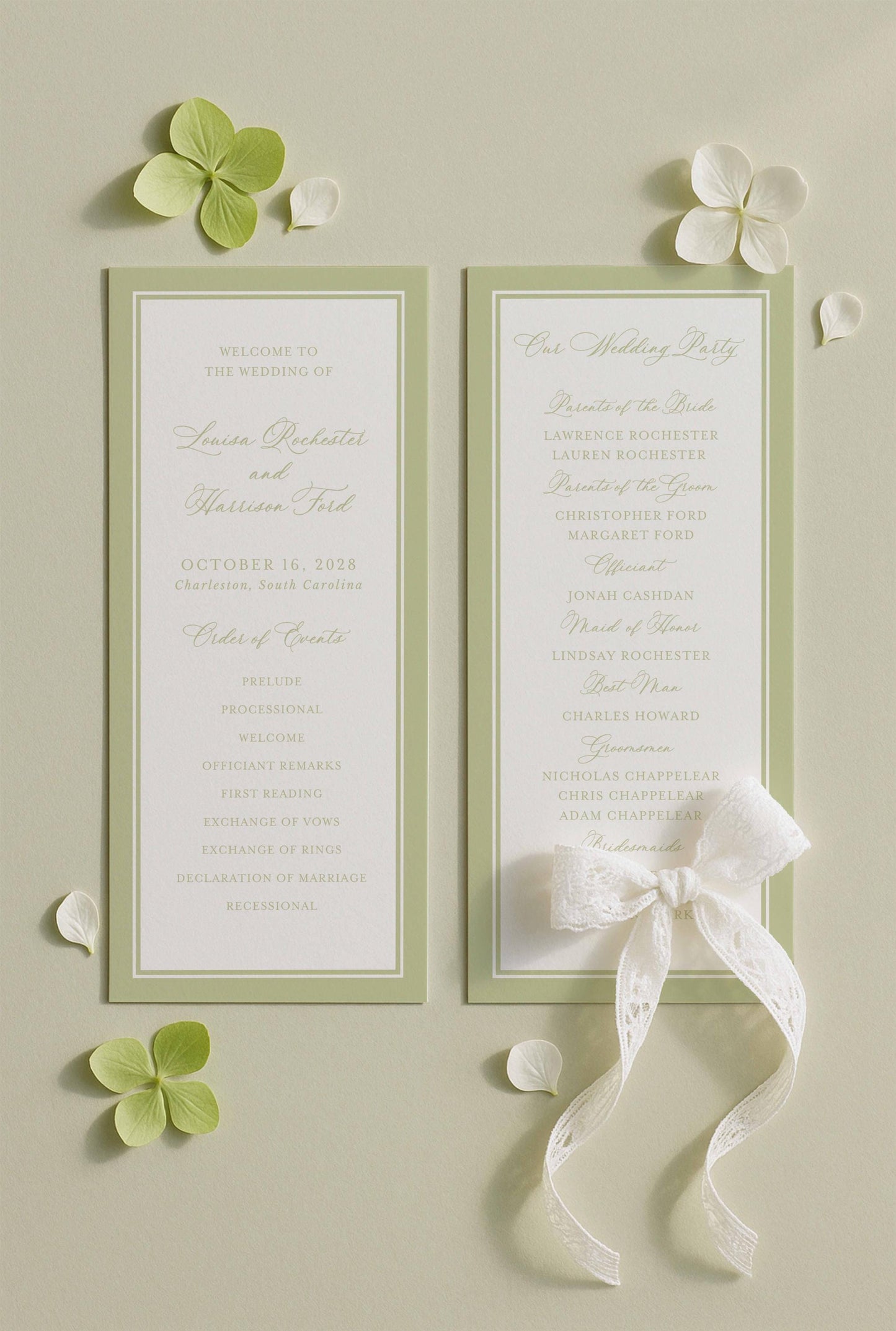 two green wedding programs with white text, placed on a light background with white flowers.