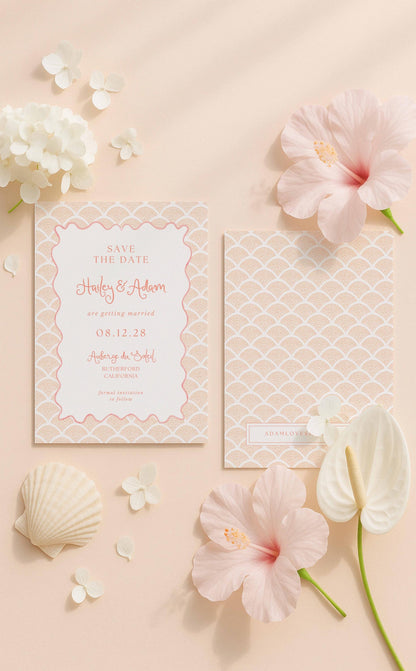 a pink and white wedding invitation card with a scalloped edge, surrounded by various floral elements such as hibiscus flowers, seashells, and a white flower.