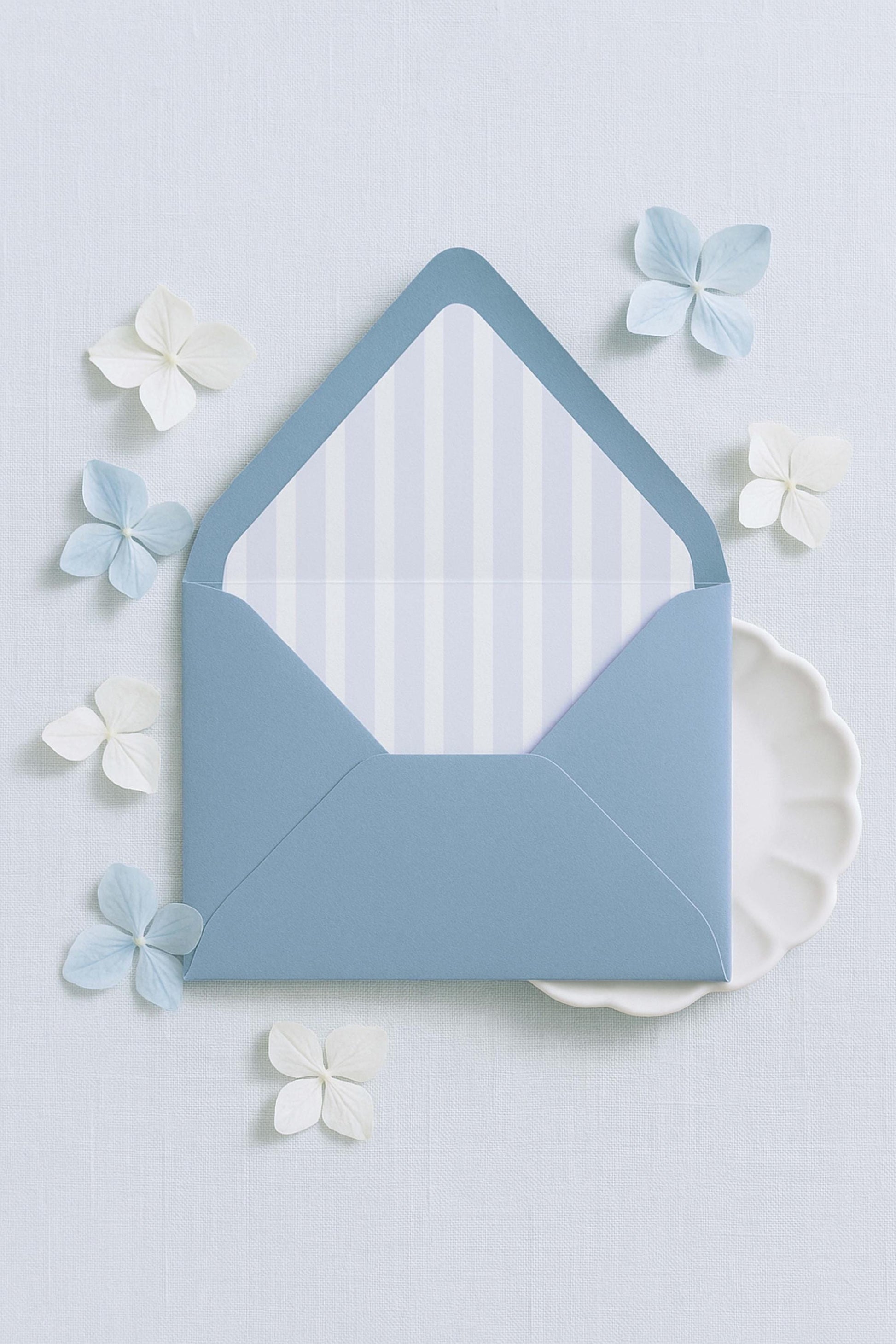 a blue envelope with a white and blue striped pattern, surrounded by small white and blue flowers on a light blue background.