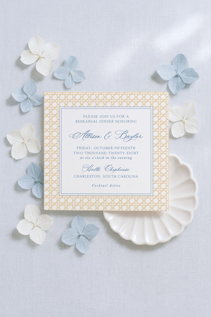 a wedding invitation card with a floral design, surrounded by small white and blue flowers on a light background.