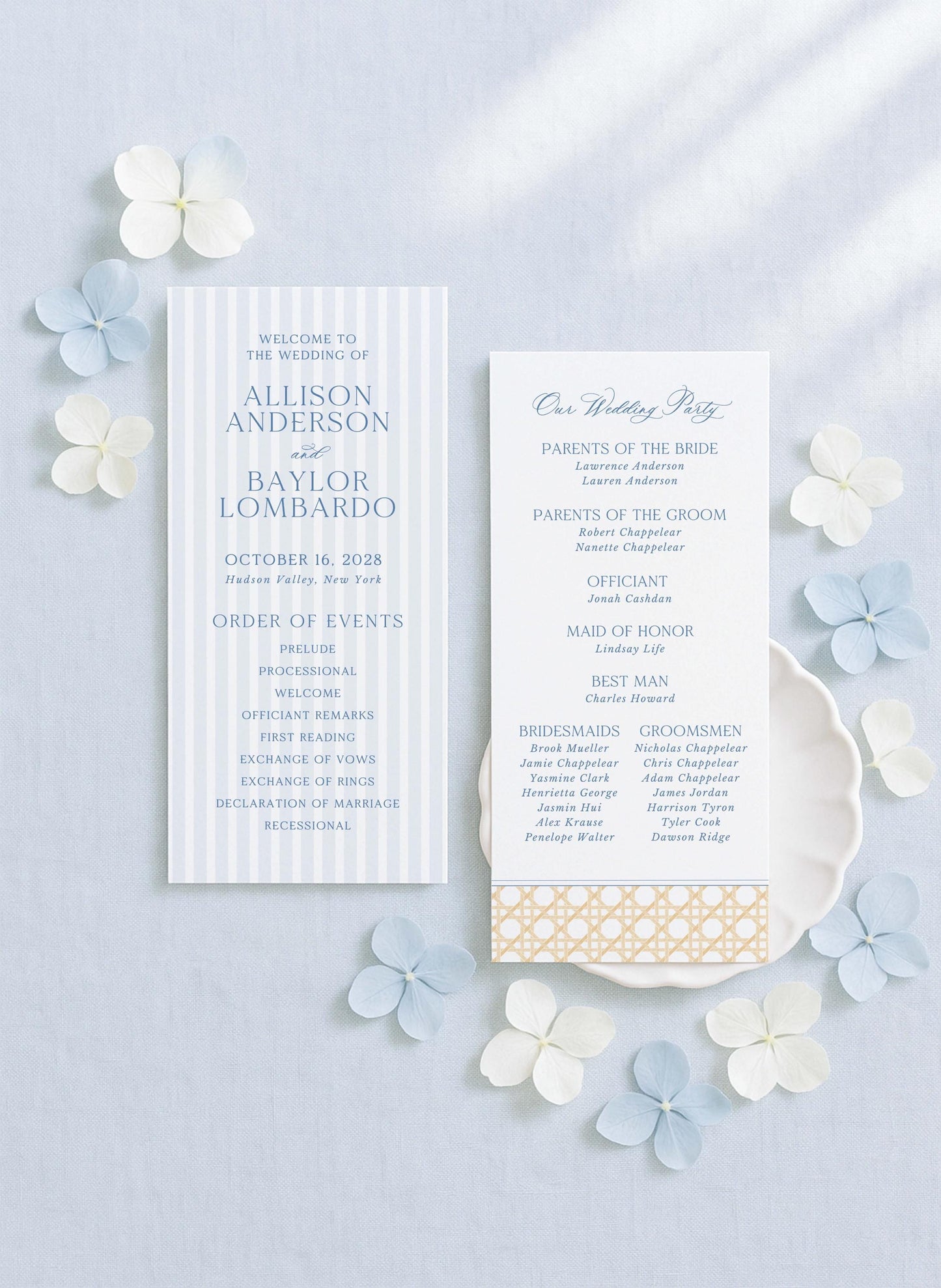 a wedding invitation card with a blue and white color scheme, surrounded by white and light blue flowers.