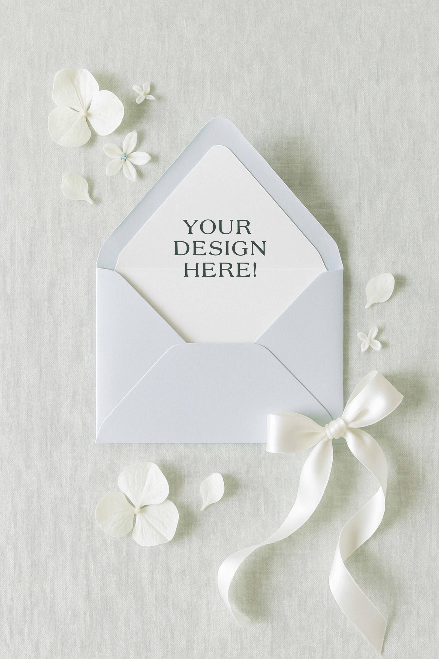 a white envelope with a bow and flowers surrounding it, along with a blank space for a message or design.