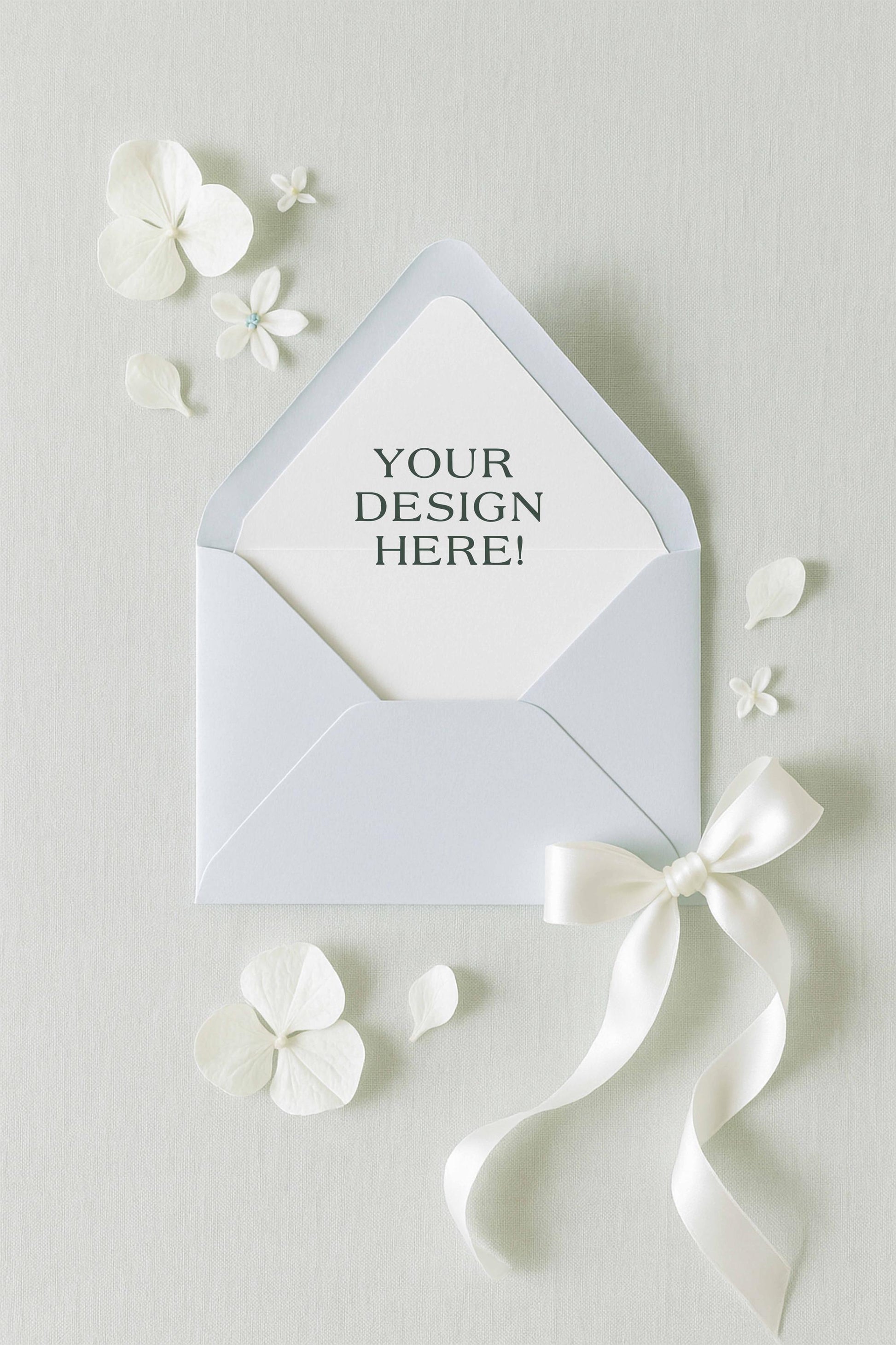 a white envelope with a bow and flowers surrounding it, along with a blank space for a message or design.