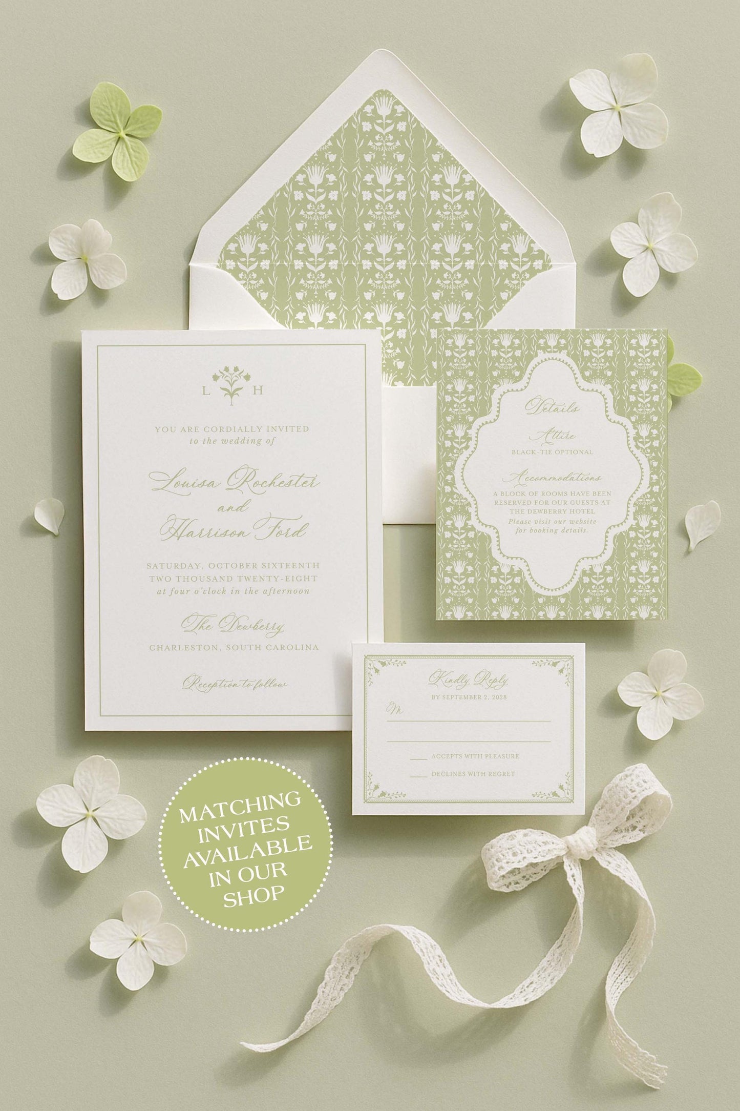 A set of wedding invitations with a matching green and white color scheme, including an envelope, a card, and a small note. The invitations are arranged on a light green background with white flowers scattered around.