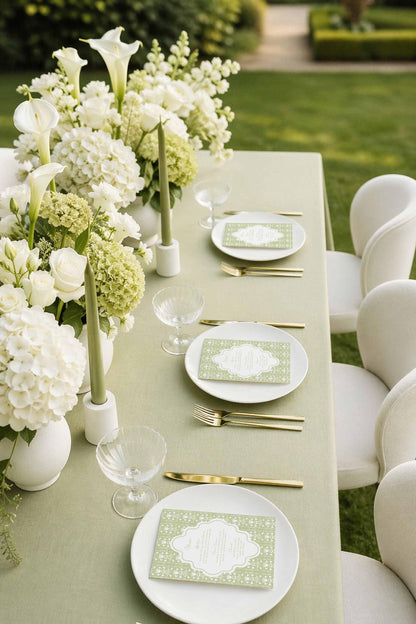 a beautifully set outdoor dining table with white flowers, plates, silverware, and glasses arranged neatly.